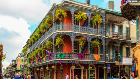Visitors explore the colorful streets of the French Quarter in New Orleans.