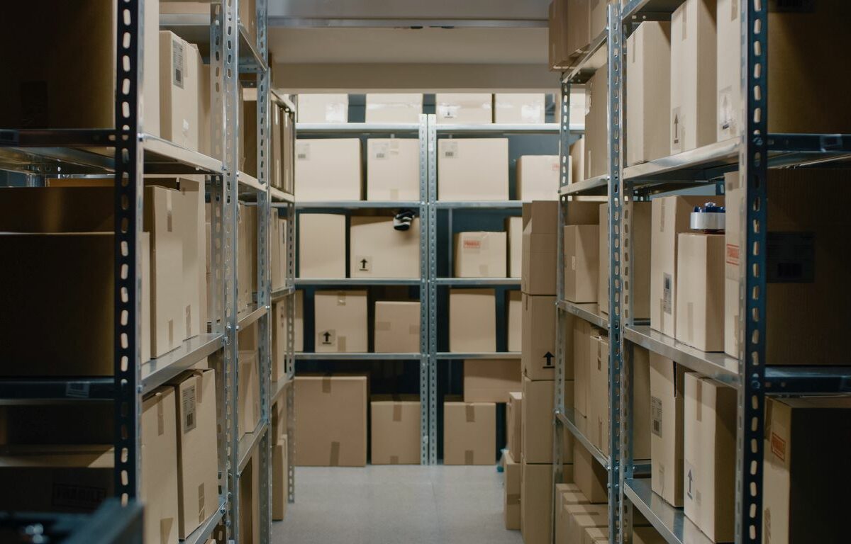 Boxes stacked on shelves in a well-organized storage unit.