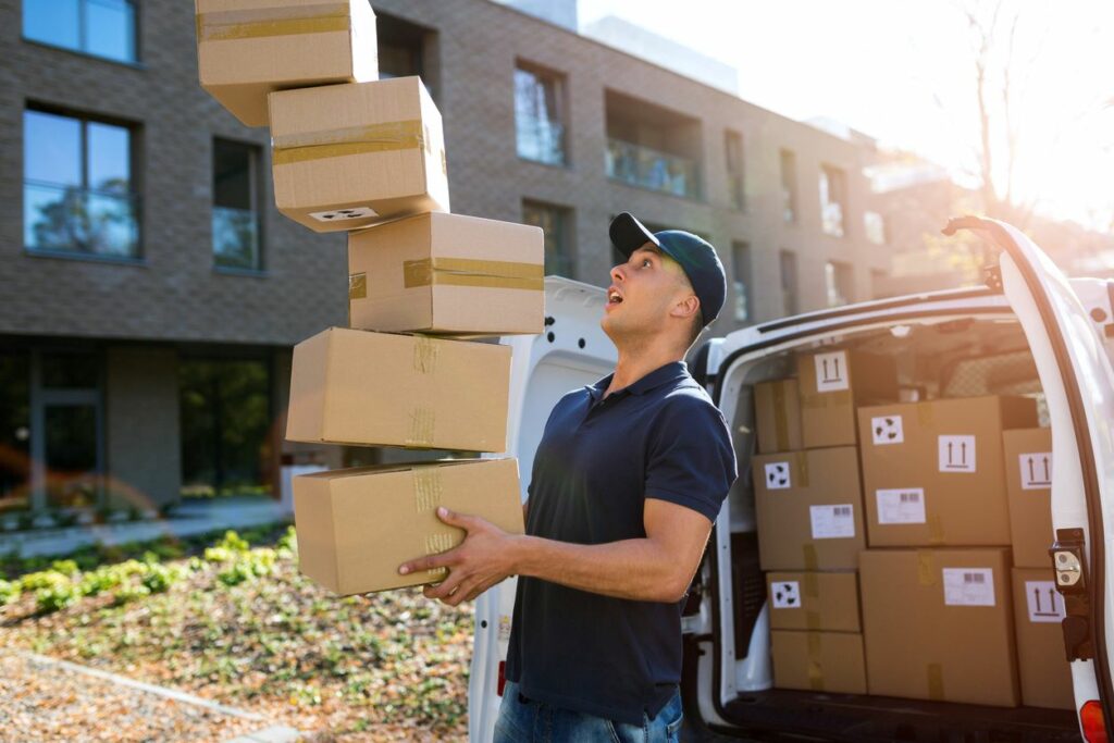 A delivery man dropping boxes. 