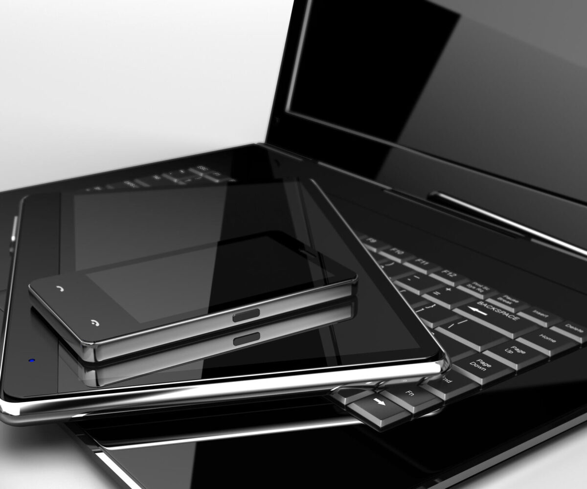 A collection of electronic devices, including a laptop, tablet, and smartphone.