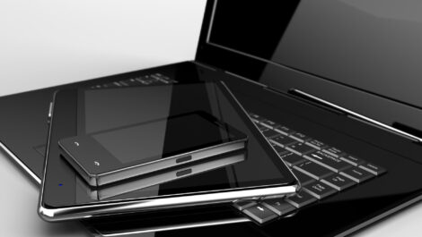 A collection of electronic devices, including a laptop, tablet, and smartphone.