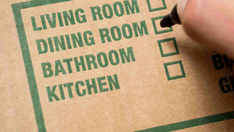 A close-up of a moving box label, with a list of rooms and check-boxes to indicate which room the box corresponds to.