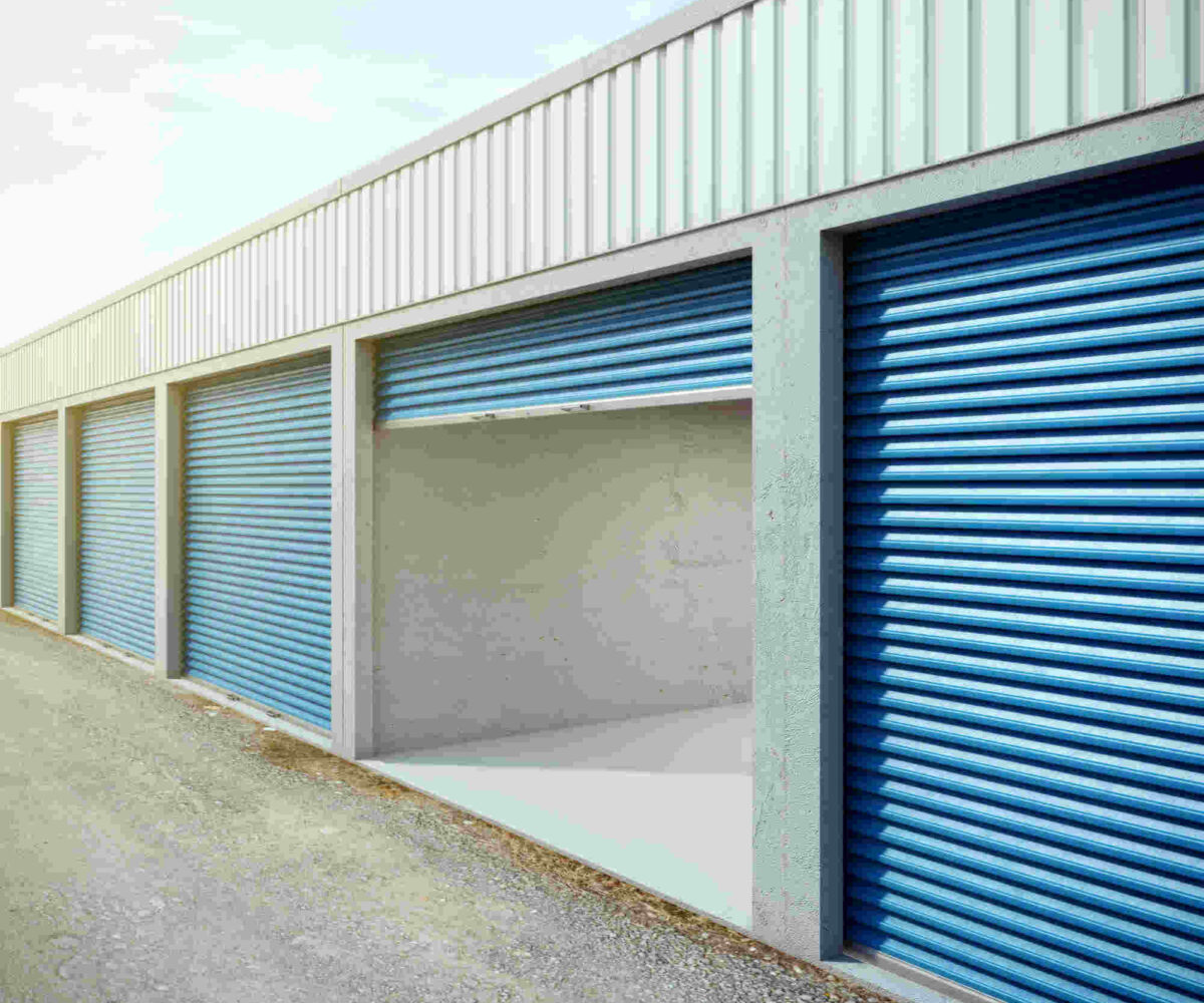 A row of storage units where two are open and you can partially see their contents.